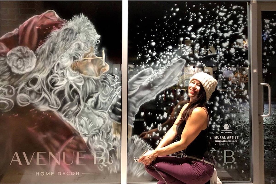 On the expansive glass canvas of a Beacon Avenue business, Santa blows snow as one might a kiss in the mural by Renee Audy. (Photo by Renee Audy)
