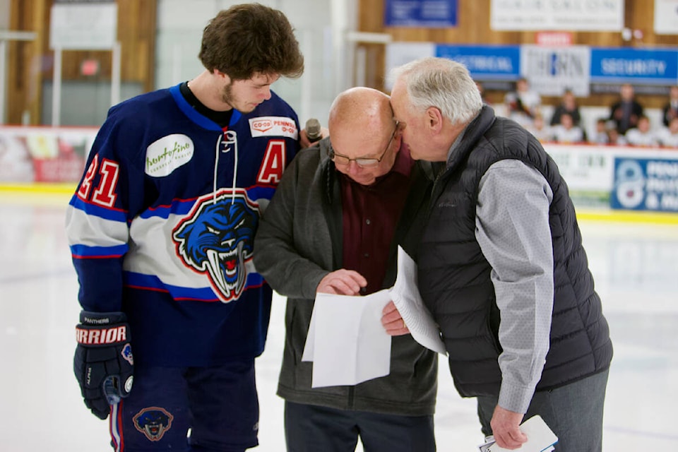 Peninsula Panthers forward Logan Speirs and owner Pete Zubersky console grandfather Don Colegrave during a memorial ceremony for Grant Gilbertson at the Panorama Recreation Centre. (Justin Samanski-Langille/News Staff)