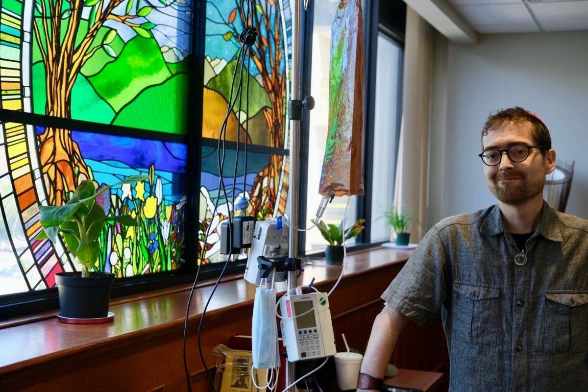 Aaron Banfield, a palliative care patient at Kootenay Boundary Regional Hospital, in August, 2022, in the room he is transforming into a sacred space for all faiths at the hospital. The space, used as a chapel in the past, already has a large secular stained glass window. (Bill Metcalfe - Nelson Star)