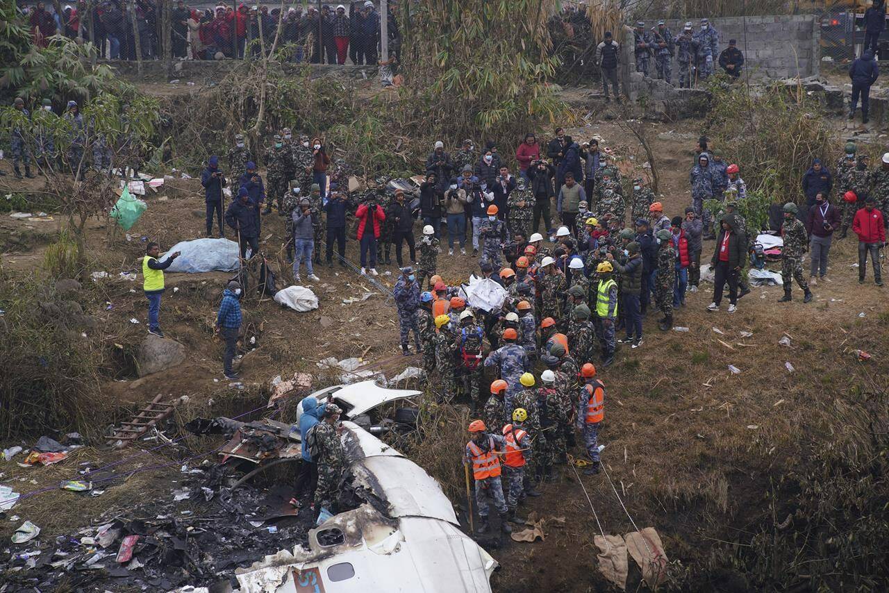 Rescuers scour the crash site in the wreckage of a passenger plane in Pokhara, Nepal, Monday, Jan.16, 2023. Nepal began a national day of mourning Monday as rescue workers resumed the search for six missing people a day after a plane to a tourist town crashed into a gorge while attempting to land at a newly opened airport, killing at least 66 of the 72 people aboard in the countrys deadliest airplane accident in three decades.(AP Photo/Yunish Gurung)