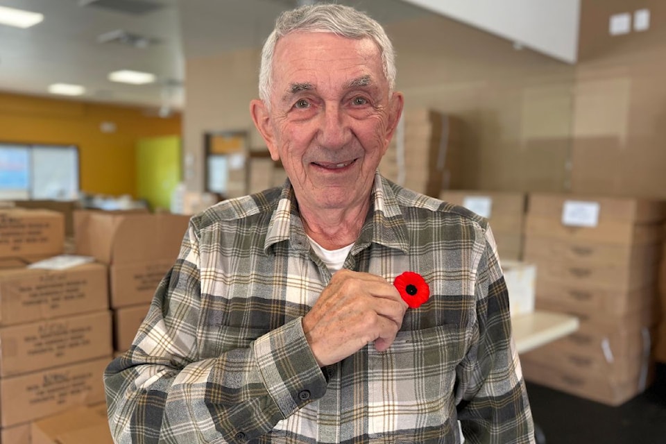 Russell Hudson pins a poppy at the Legion Branch No. 37 office.