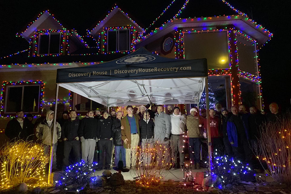 Past and current clients of Discovery House gather outside the non-profit's Winnipeg Street home for the annual Shed the Light on Addictions fundraiser on Saturday, Dec. 14, 2024.
