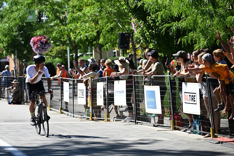 Summerland's Lee Agur interacts with his cheering family as he approaches the finish line of the Okanagan Granfondo in Penticton.