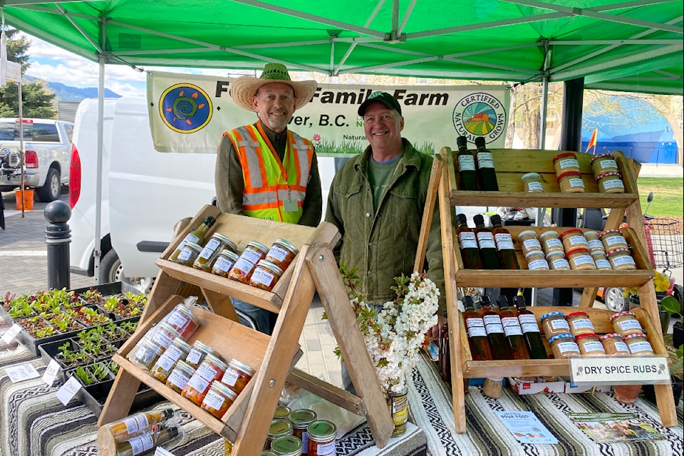 Philip Solman, assistant manager of the Penticton Farmers' Market (left) with an Oliver vendor at the event on Saturday, April 19.