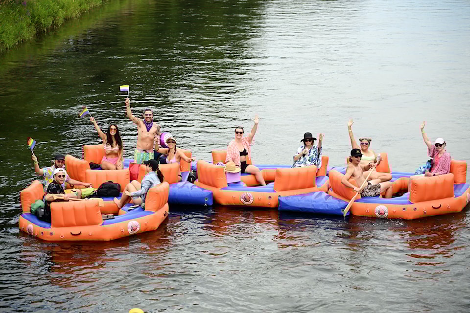 Participants of the 2025 Fruit Float, organized by South Okanagan Similkameen Pride, wave as they take part in the event down the Penticton Channel on July 26, 2025.