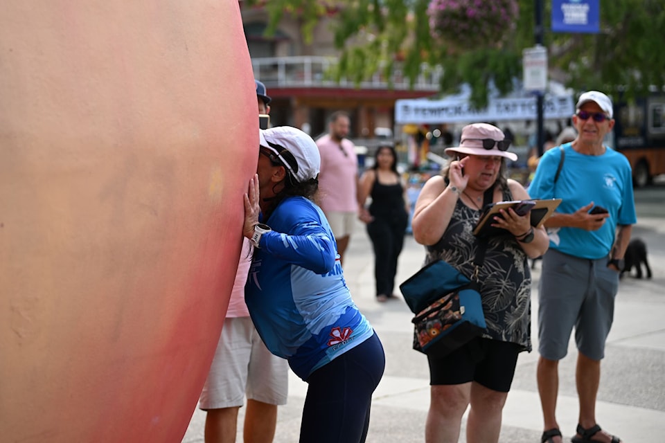 One of the paddlers from the Vancouver Rapid team kisses the Peach in Penticton to finish off the 2025 Length of the Lake race. 