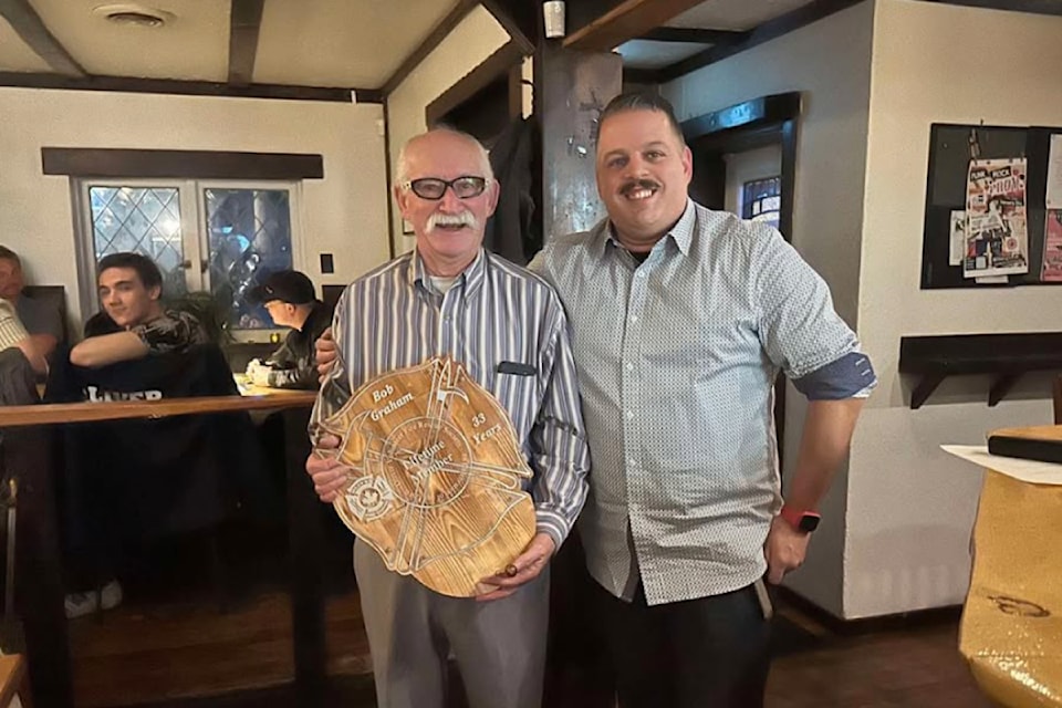 Rob Graham, right, presents his father Bob Graham with the Life Member Award with the Oliver Fire Department. Bob retired as fire chief in later 2024 after 33 years of service.