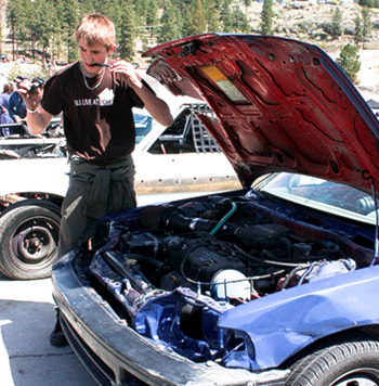 Young racer Jeremy Vass works on his '90s Honda Civic before the races.