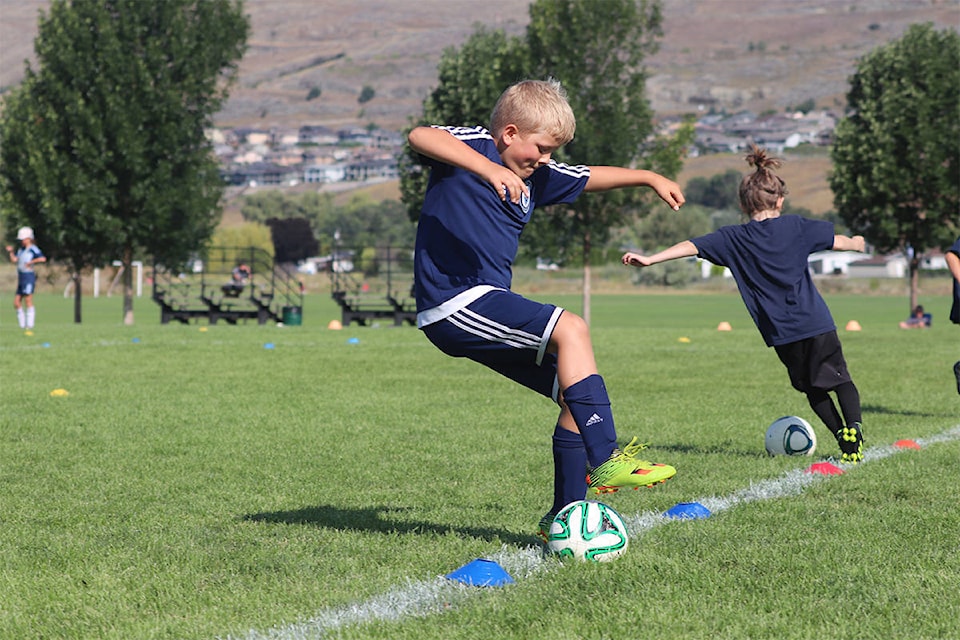 A youth soccer player makes a 180-degree turn at the Whitecaps FC summer camp on Aug. 14 at Marshall Field. Photo: Brendan Shykora - Morning Star Staff