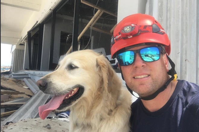 Penticton fire chief Larry Watkinson and his disaster dog Sammy in the Bahamas. (Photo courtesy of Penticton Fire)