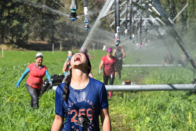A Freak’n Farmer pauses for a water break during the 8th annual obstacle race. (Brennan Phillips - Western News)