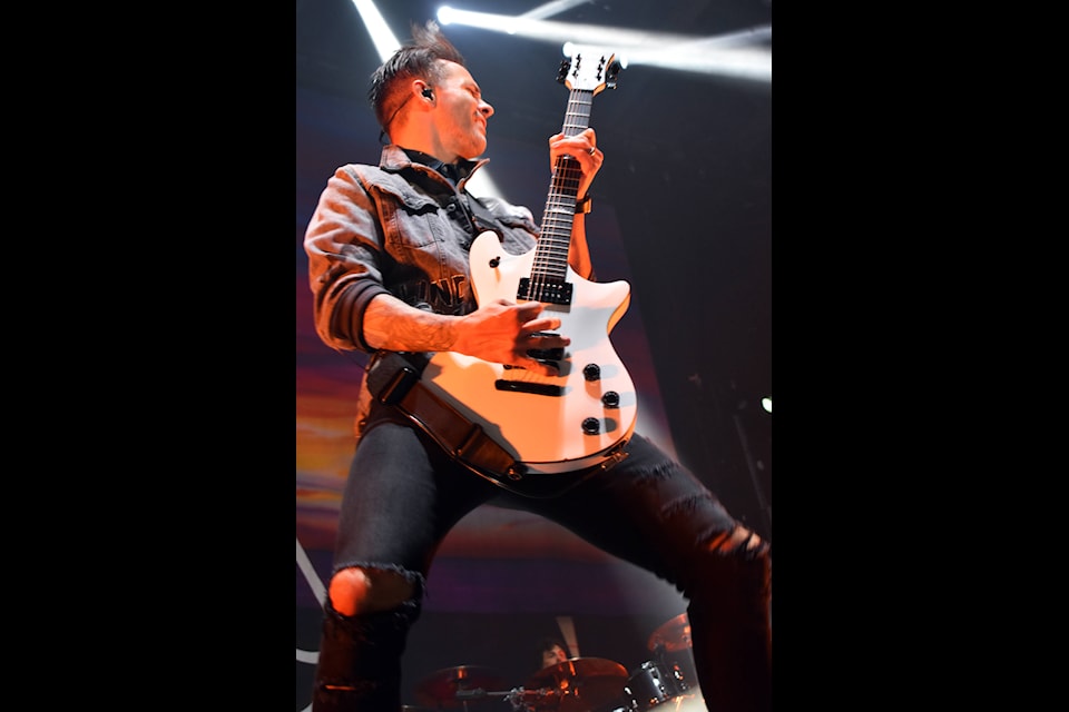 Papa Roach guitarist Jerry Horton bounces about while playing his guitar during the band’s show with Shinedown in Penticton on Oct. 15. (Brennan Phillips - Western News)