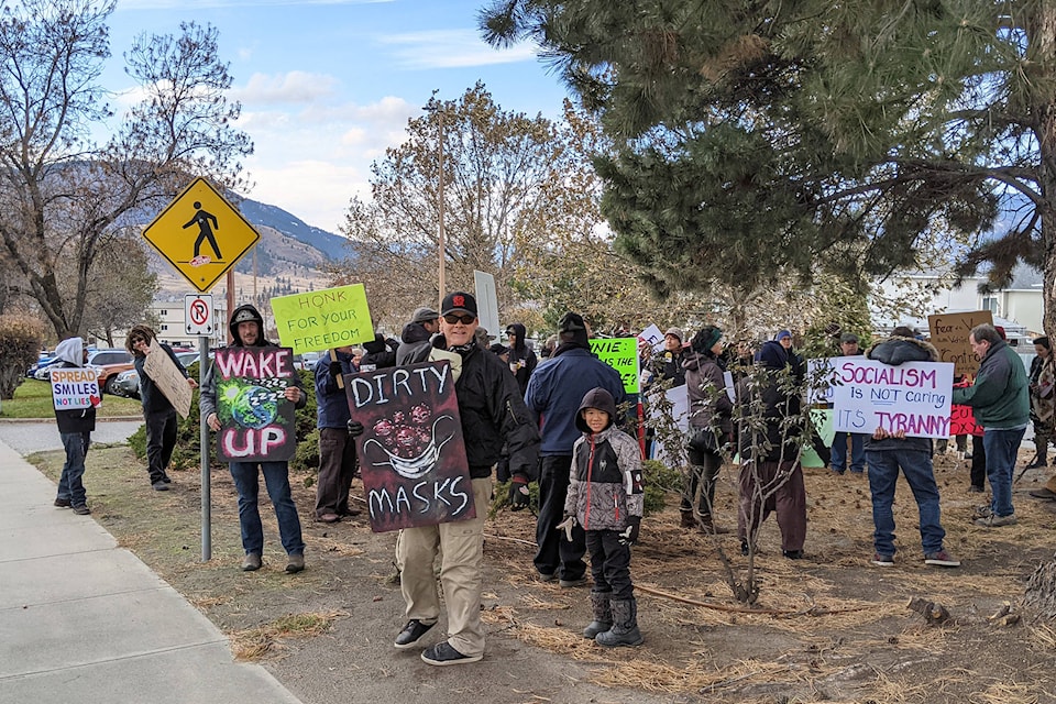 A group of approximately 40 people hit the streets Sunday, Nov. 22, 2020 in Penticton to protest the measures that have been implemented to control the spread of COVID-19. (Jesse Day - Western News)