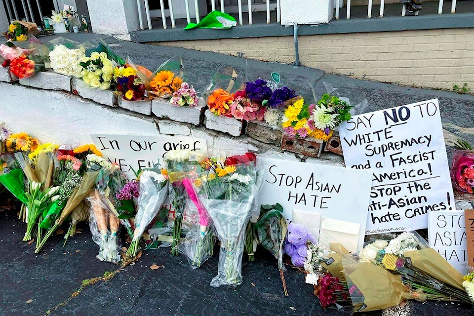 FILE - In this March 19, 2021, file photo, flowers, candles and signs are displayed at a makeshift memorial in Atlanta, following a shooting. The murder case against Robert Aaron Long, a white man accused of shooting and killing six women of Asian descent and two other people at Atlanta-area massage businesses, could become the first big test for Georgia’s new hate crimes law. (AP Photo/Candice Choi, File)