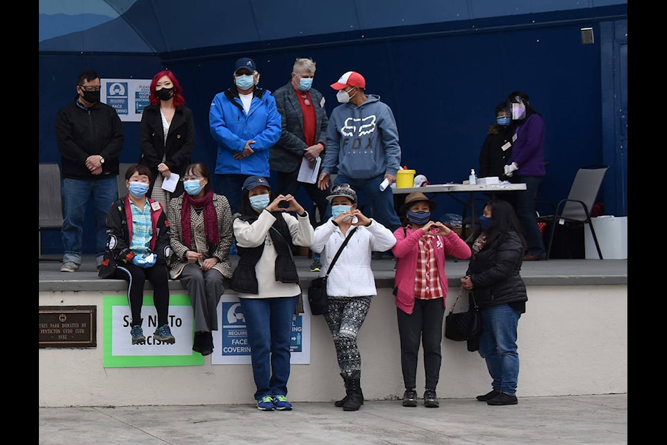 Organizers of Sunday’s rally against Asian racism make heart shapes with their hands to show love, not hate is needed. (Monique Tamminga Western News)