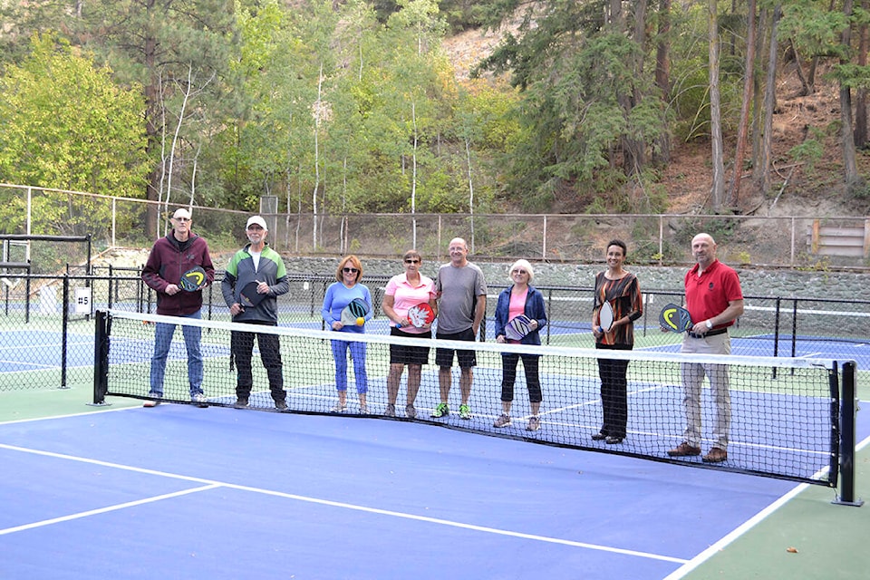 Summerland mayor Toni Boot with councillors, staff and members of the Summerland Pickleball Club stand in the new public courts at the Peach Orchard campground. (Monique Tamminga Western News)