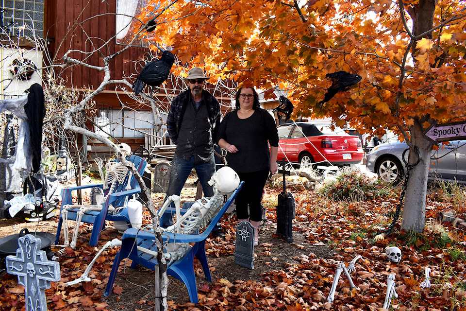 Neil and Rachel Terry stand among skeletons and graveyards in their haunted display at 920 Killwinning St. in Penticton. (Monique Tamminga - Western News)
