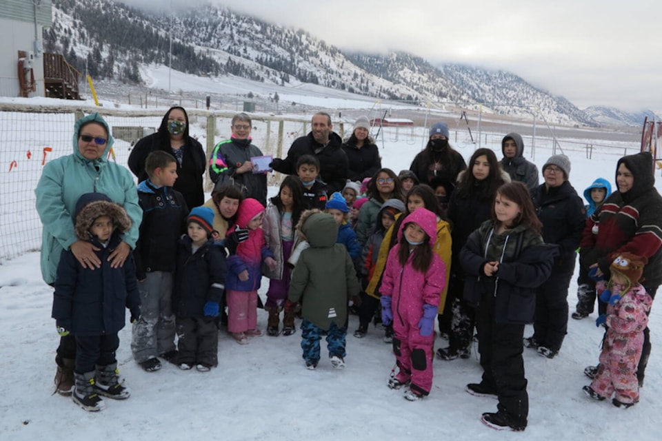 Arlene Arlow (back row third from left) from the Similkameen Country Chamber of Commerce visited the Ntamtqensnma?maya?tn Band School on December 10th to present Principal Stuart Krestell (back row centre) with a certificate from Boboys Pizza and Donair in Keremeos for winning one of three youth awards. (Sydney Crow - Submitted)