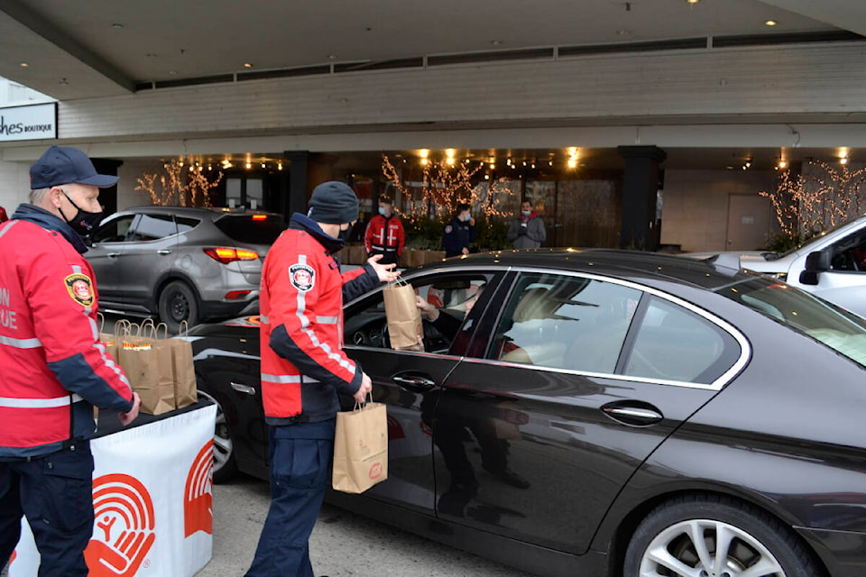 Penticton firefighters were handing out breakfast bags at Penticton Lakeside where there was a steady stream of vehicles coming to the 10th United Way Drive Thru March 2. (Monique Tamminga Western News)