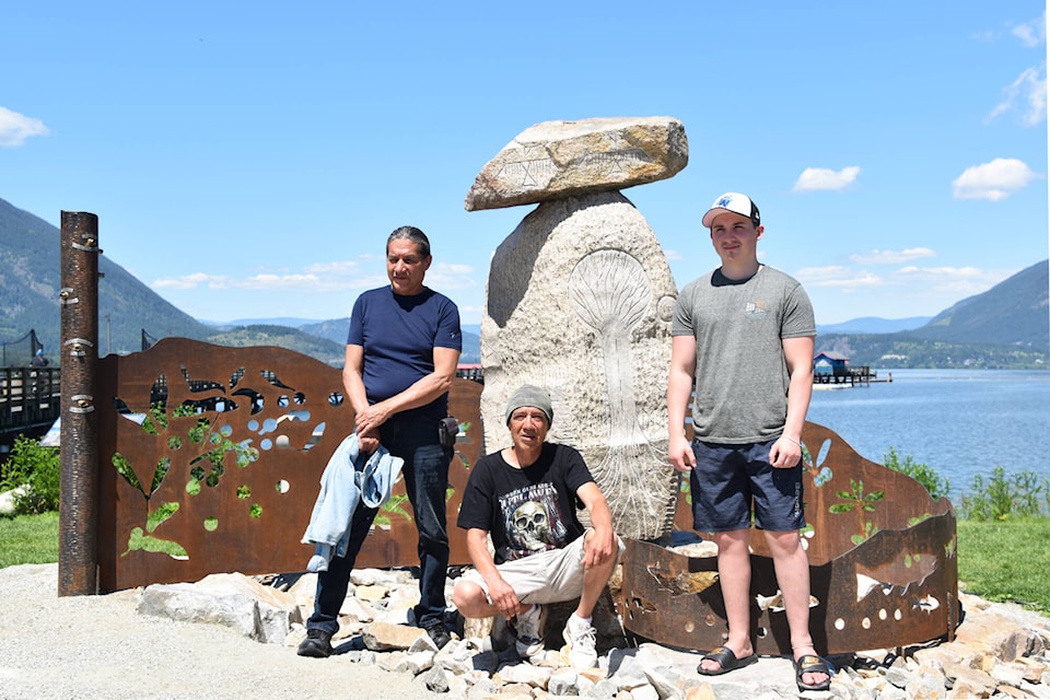 From left, Ron Tomma, Rod Tomma and Tilkotmes Tomma stand with the Sxwesméllp Landmark after it was unveiled following a celebration and ceremony on June 25, 2022 in Marine Peace Park in Salmon Arm. Rod and his son Tilkotmes Tomma were the main carvers of Coyote Rock, while Rod’s cousin Ron helped them finish off the sculpture. (Martha Wickett-Salmon Arm Observer)