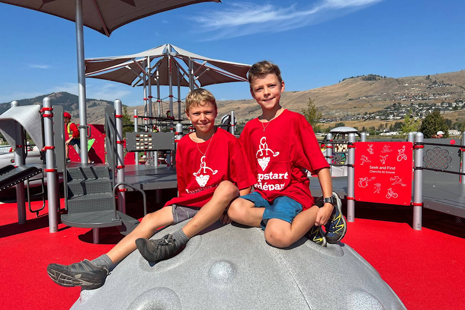 Kevin and Kyle Soanes sit atop an igloo-shaped structure at the inclusive playground at Vernon’s Parshall Field Park, which opened in the fall and was officially celebrated Thursday, Aug. 18, 2022. (Brendan Shykora - Morning Star)