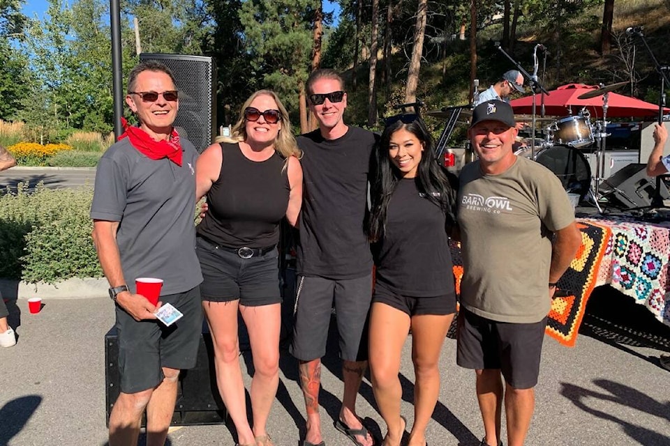 Nori Wentowrth stands with wife Kristyn, Barn Owl Brewing staff, and a Tommy Gun’s barber after shaving his beard in support of Kelowna General Hospital’s renal ward (Brittany Webster - Capital News)