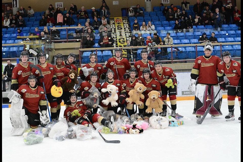 The West Kelowna Warriors pose for a photo after beating the Vernon Vipers on Teddy Bear Toss night at Royal LePage Place. (West Kelowna Warriors/Tami Quan Photography)