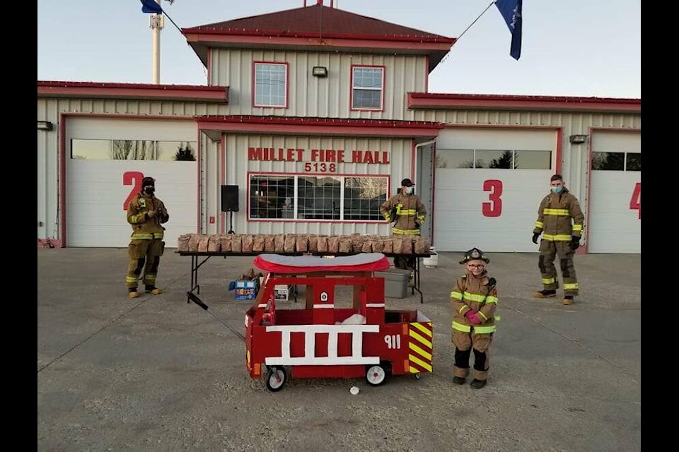 Firefighters at Millet Fire Department prepare to hand out candy bags with donated candy to Millet trick-or-treaters. Photo/ Luke Jevne.