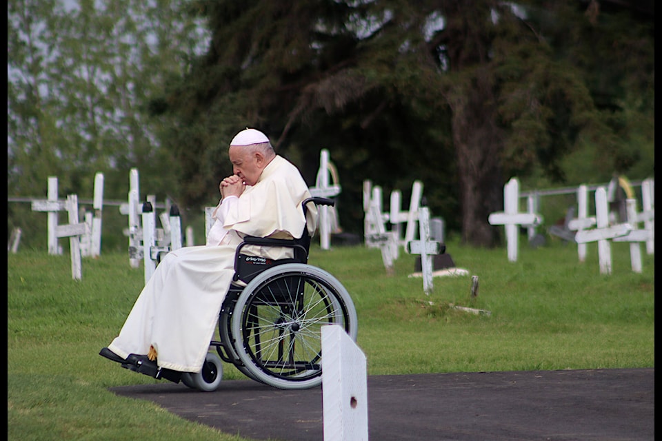 (Emily Jaycox/Ponoka News) Pope Francis spends a few minutes praying alone at the Ermineskin Cemetery July 25. (Emily Jaycox/Ponoka News)