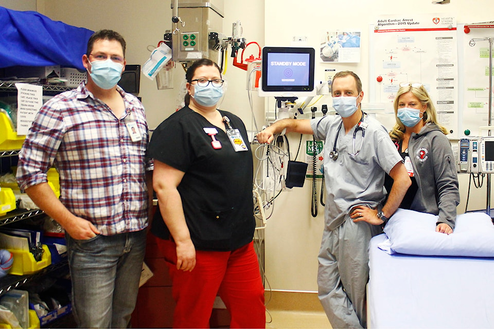 Hospital personnel pose for a photo with one of the cardiac monitoring cubes in emergency. L-R: assistant head nurse Jamie Havanka, RN Melanie Dudar, Dr. Gregory Sawisky and RN Cindy Bonnett. Photos by Emily Jaycox