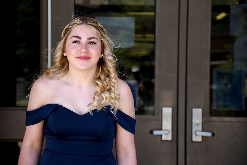 Bailey Donison smiles for a photo at St. Augustine School in Ponoka on Friday, June 4, 2021. The graduation ceremony adhered to the COVID-19 measures put out by the province. Graduates walked the stage in five minute increments, and the ceremony was livestreamed on Facebook. (Photo by Madison Fleck/SAIT)