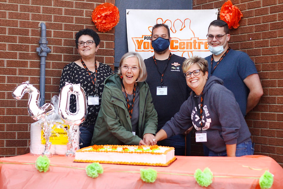 Cutting the cake: On Sept. 10, 2021, the Ponoka Youth Centre celebrated the 20th anniversary of opening its doors. Pictured here are Joziena Meijer, Heather Patterson, Darryl Stretch, Jesse Vaudry and Beth Reitz, executive director. (Emily Jaycox/Ponoka News)
