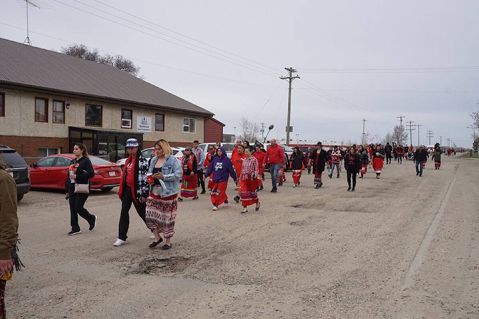 Dozens walked through Maskwacis at the Ermineskin Cree Nation Townsite May 5, 2022, for Red Dress Day raising awareness for MMIWG. (Shaela Dansereau/ Pipestone Flyer)