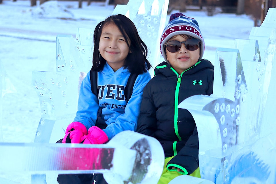 L-R: Penelope and Hiro Kaquitts pose for a photo in the ice sleigh at the downtown plaza. (Emily Jaycox/Ponoka News)