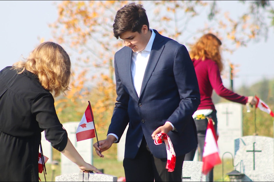 The Ponoka Legion observed Decoration Day on Sept. 16, placing Canadian flags on headstones of service members. A history of Decoration Day was given, explaining it was how veterans were recognized before World War I. In attendance were legion members, Lacombe-Ponoka MLA Jennifer Johnson, Mayor Kevin Ferguson, county Coun. Bryce Liddle, and Ron Labrie and his Broncs World Tour students. (Photos by Emily Jaycox/Ponoka News)