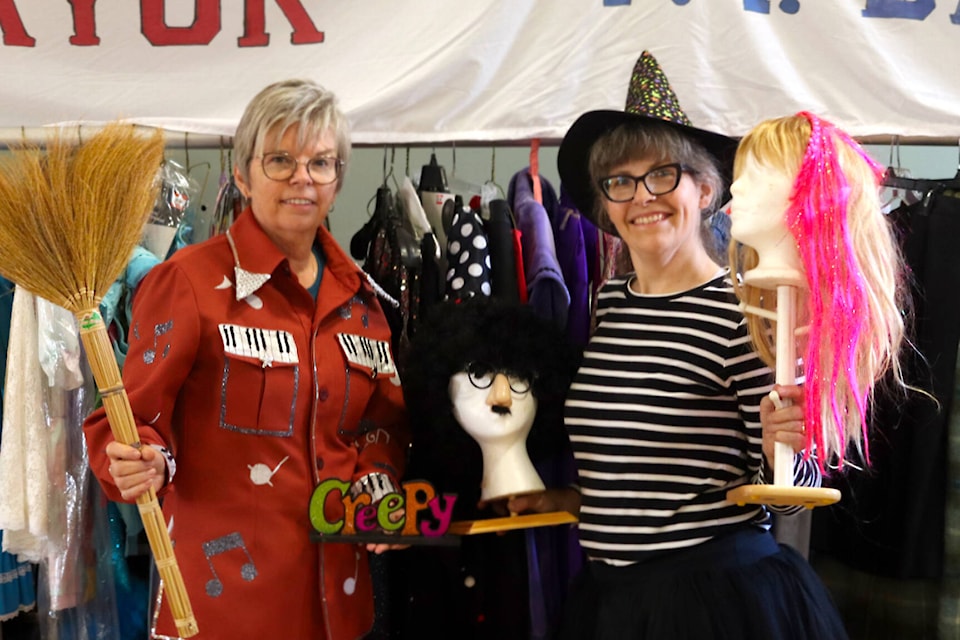 Ponoka United Church hosted its annual community garage sale alongside Ponoka Community Theatre - KFA’s Halloween sale from Sept. 15 to 16. KFA said they will likely hold another sale of the theatre’s old costumes closer to Halloween. Pictured here, Susan Chantal, left, and Marissa Kochanski show off some of the cool props and outfits from past plays. (Photos by Emily Jaycox/Ponoka News)