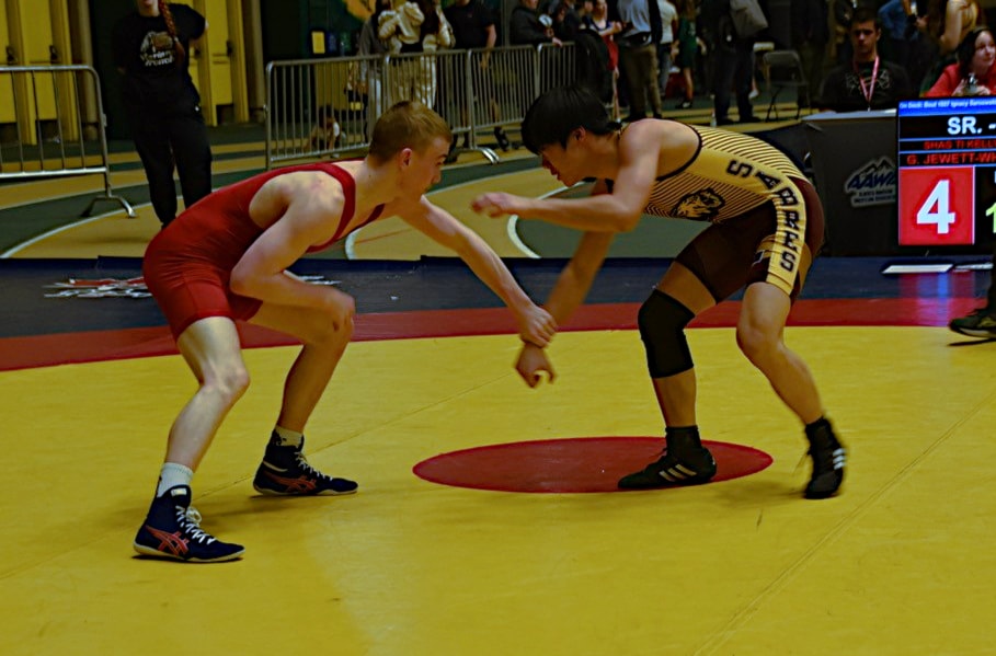 Grade 12 wrestler Kalan Chui, right, In his wrestling stance.