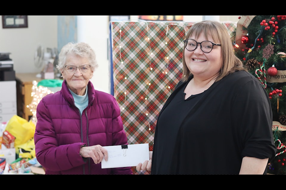 Left, Violet Smith, Ponoka Food Bank manager, accepts $130 in cash donations from Ponoka News regional publisher Christina Komives on Nov. 18. 
 