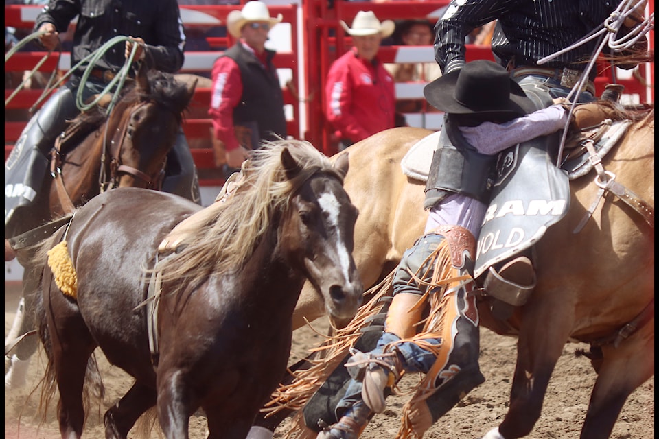 A young saddle bronc rider is rescued by a Wrangler. 