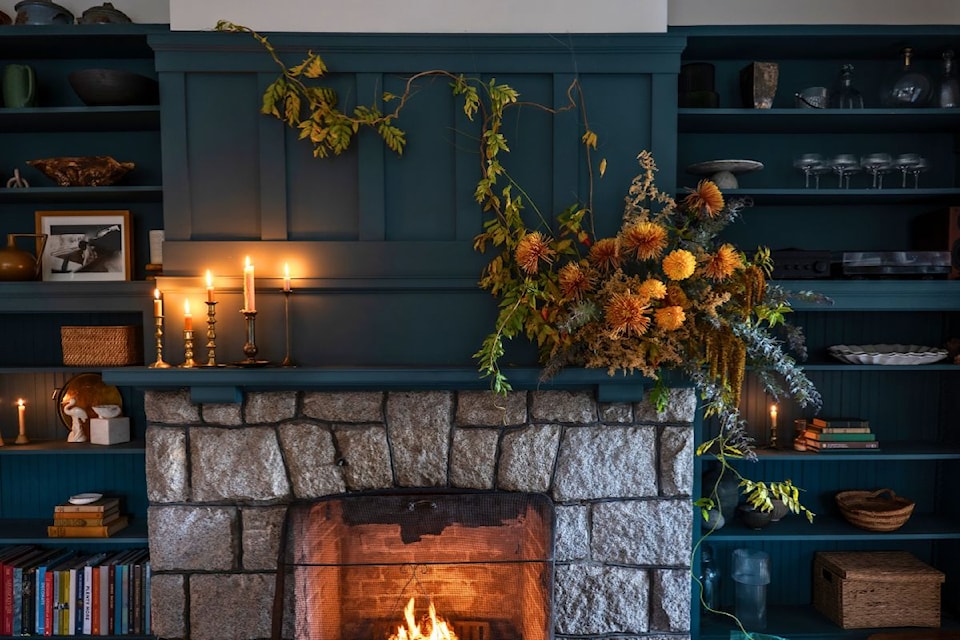 This mantle decor by Julie Remy uses wisteria, dahlias, chrysanthemum, dried astilbe, lysimachia clethroides (Gooseneck Loosestrife) foliage, and acacia foliage. 