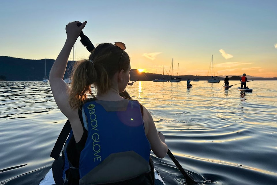Paddle boarding at sunset with Mer Tales.