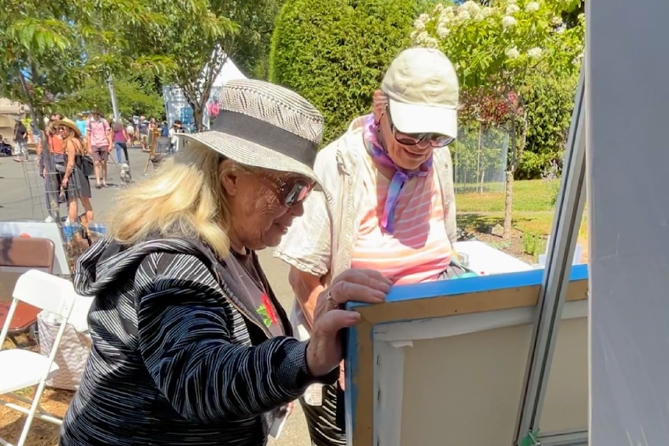 Artist Carole Finn (left) at the Art Gallery Paint-In in 2024.