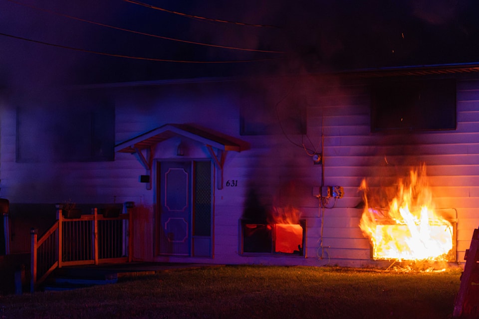 Flames are clearly visible coming out of the windows of a building on Nason Street in Quesnel, Monday, Nov. 11. 