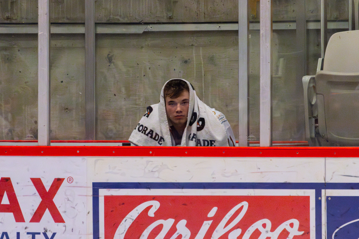 Toren Fron sits in the penalty box, looking sad with a towel resting on his head