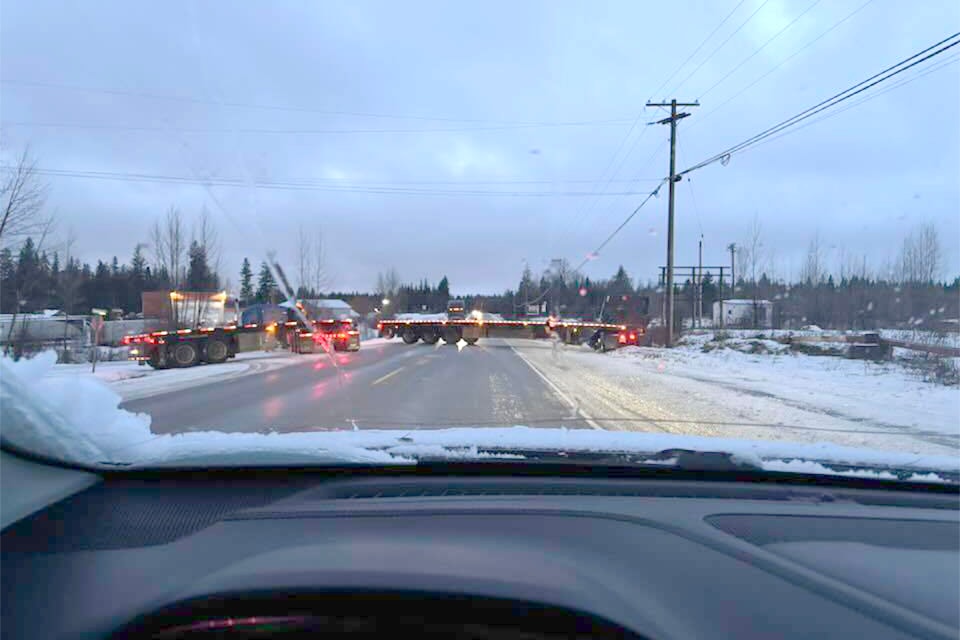 A photo showing the incident that caused the highway closure. Semi trucks are blocking both lanes.