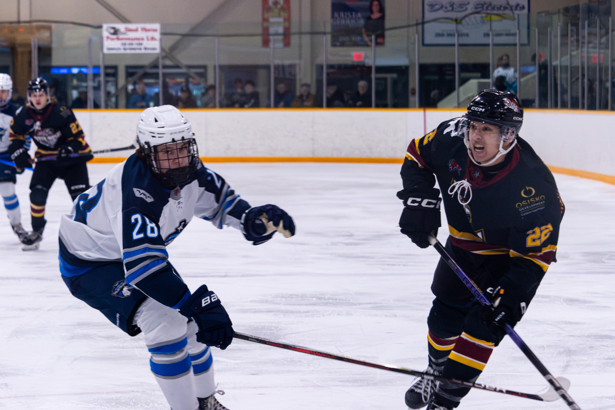 Adam Valach goes for the puck in a hockey rink