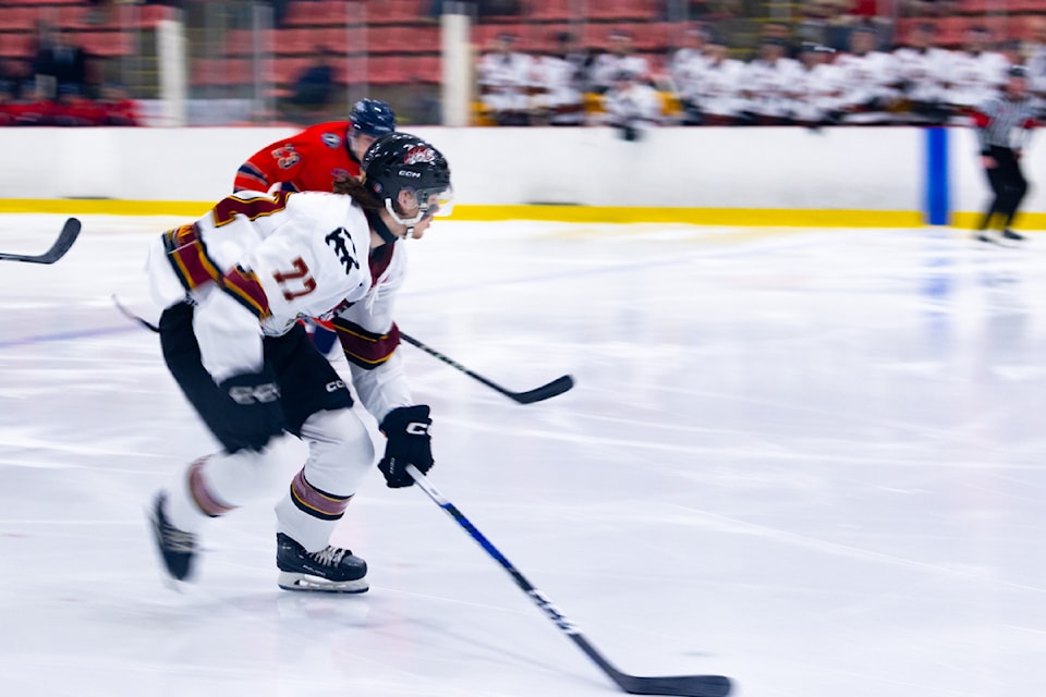 Ian George races for the puck.