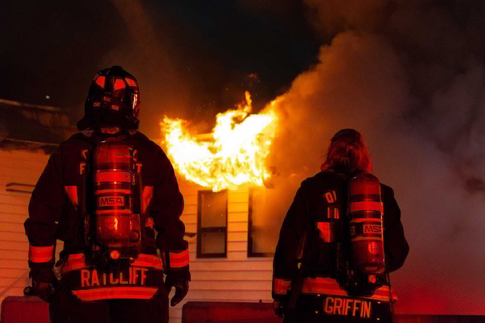 Firefighters take a well-deserved breather as the flames creep out of the building.