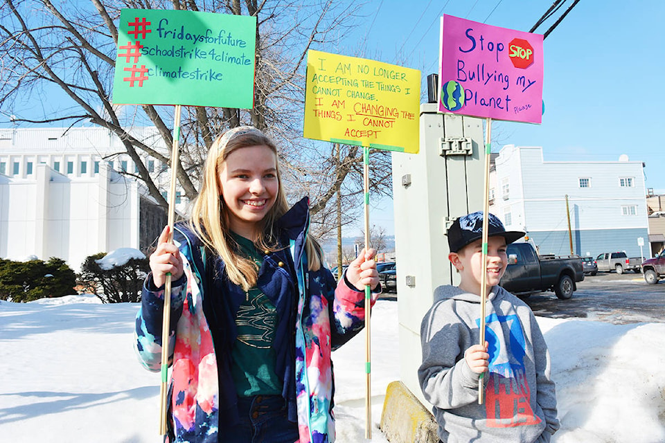 Twelve-year-old Aja Bedard of Wells and her 10-year-old brother, Chace, wave signs during the Fridays for Future Strike March 15. Lindsay Chung photo