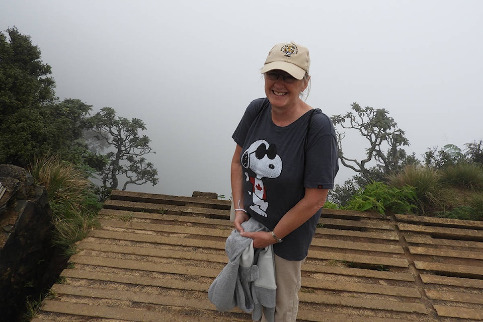 Above, Joan McNaughton smiles for a photo on the platform at Land’s End in Hortons Plain National Park. McNaughton, who doesn’t like heights, says she was happy she couldn’t see how far the drop was through the cloud. At left, a bird from the Hornbill family on a tree branch in Sri Lanka. McNaughton says birding is “fantastic” in Sri Lanka. Joan McNaughton photos